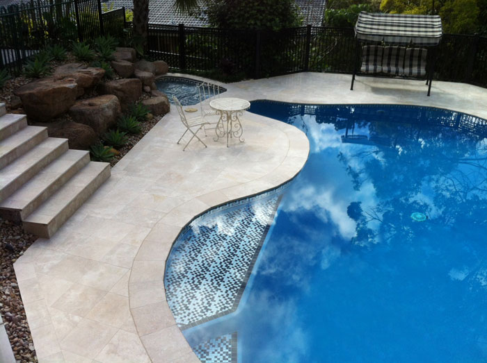 Travertine Linen stone tiles and coping around swimming pool