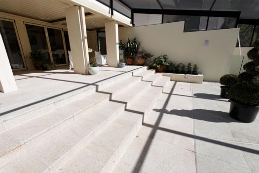 Almond Granite Paving stone tile or pool paver shown in situ with matching coping