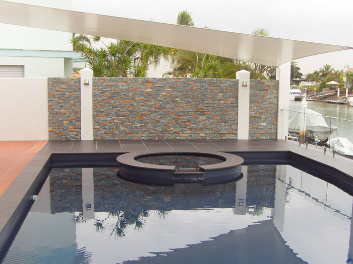 Black Granite stone tile or pool paver shown in situ with matching coping