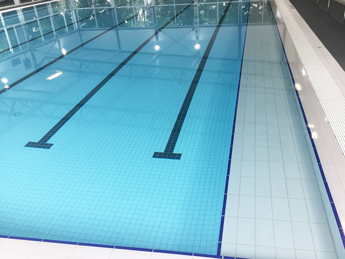 Fully tiled indoor pool in CM115 White 58mm with CM120 Black used as lane marking tiles. 