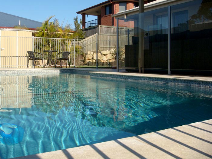 Crema Limestone stone tile or pool paver shown in situ with matching coping