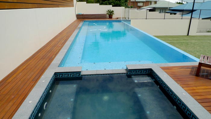 Dark Grey Granite stone tile or pool paver shown in situ with matching coping