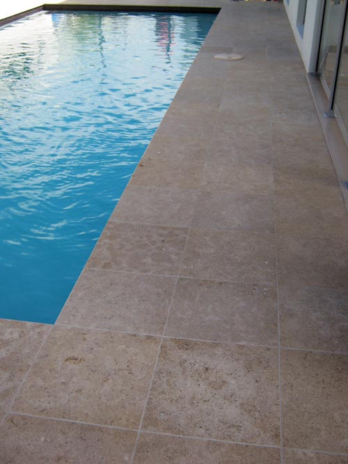 Dune Limestone stone tile or pool paver shown in situ with matching coping