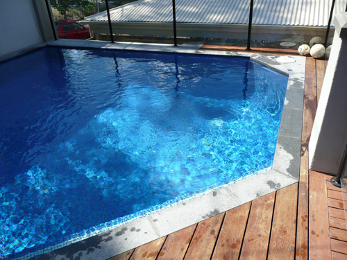 GCR050 Azure Blue glass mosaic pool tile shown in situ