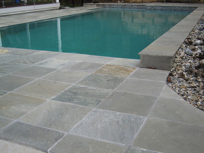 Grey Gum stone tile or pool paver shown in situ with matching coping