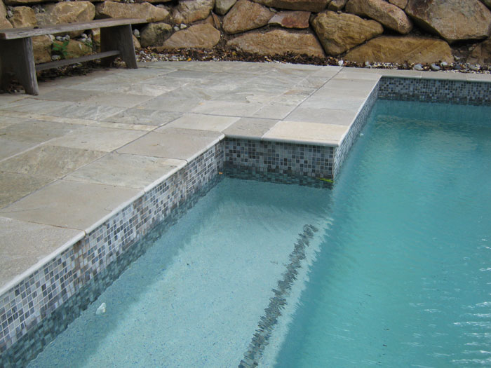 Grey Gum stone tile or pool paver shown in situ with matching coping