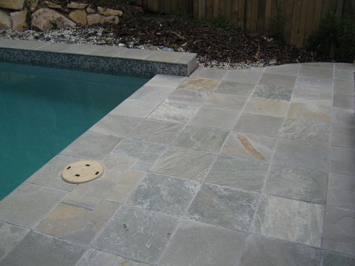 Grey Gum stone tile or pool paver shown in situ with matching coping