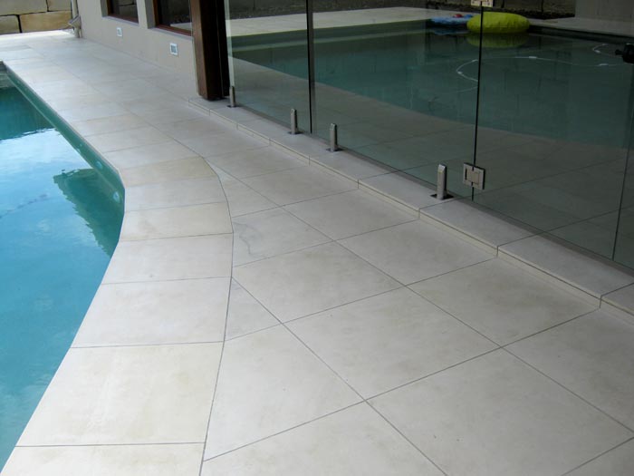 HQHoned Mint stone tile or pool paver shown in situ with matching coping