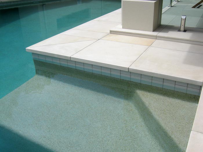 HQHoned Mint stone tile or pool paver shown in situ with matching coping