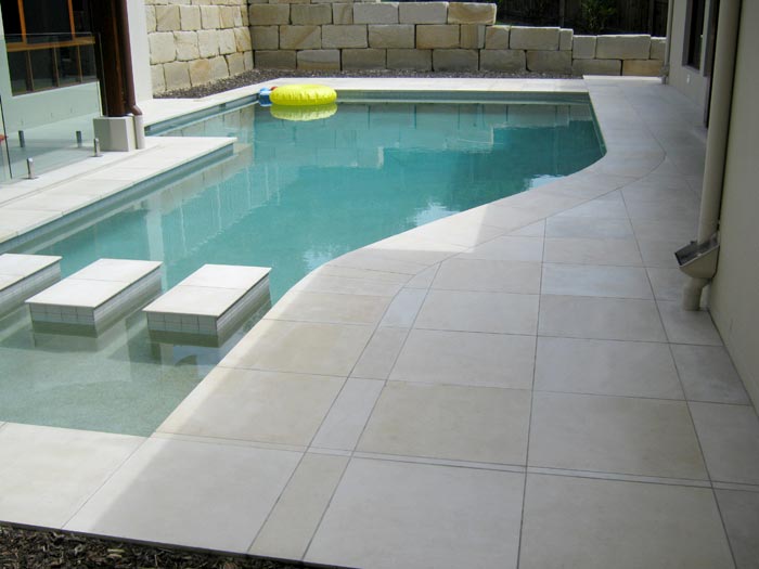 HQHoned Mint stone tile or pool paver shown in situ with matching coping