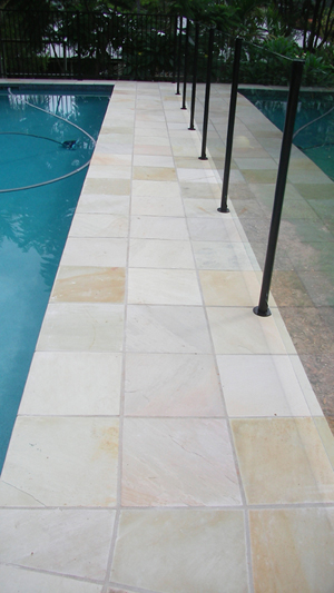 HQ Natural stone tile or pool paver shown in situ with matching coping