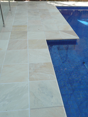 HQ Natural stone tile or pool paver shown in situ with matching coping