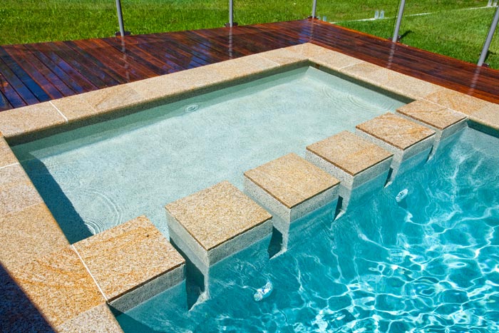 Honey Granite stone tile or pool paver shown in situ with matching coping