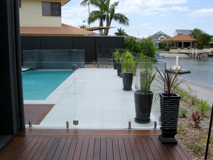 Light Grey Granite stone tile or pool paver shown in situ with matching coping