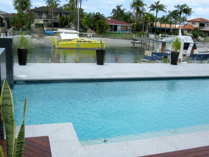 Light Grey Granite stone tile or pool paver shown in situ with matching coping