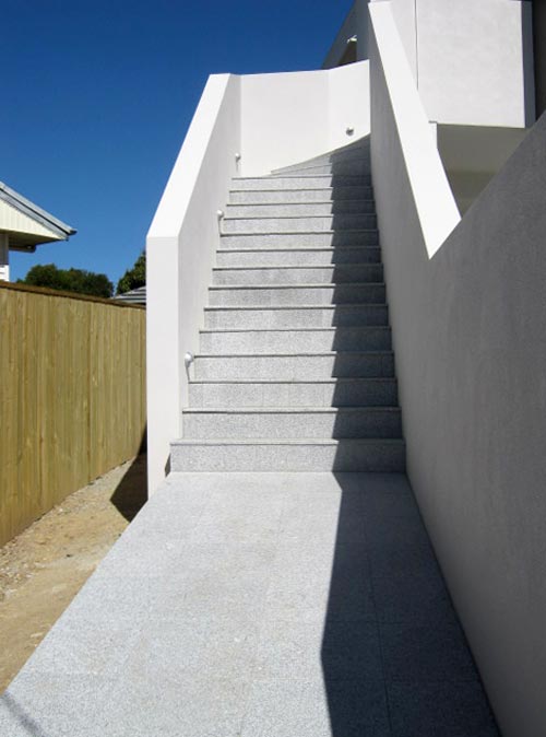 Light Grey Granite stone tiles shown here being used for an external staircase and paving in a domestic environment