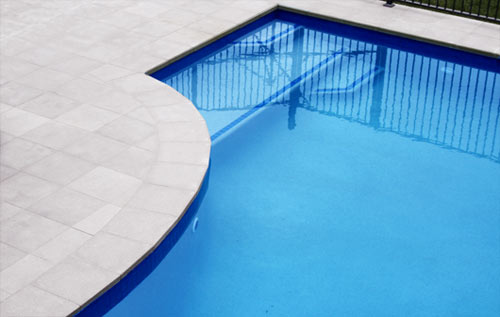 Mushroom Granite stone tile or pool paver shown in situ with matching coping