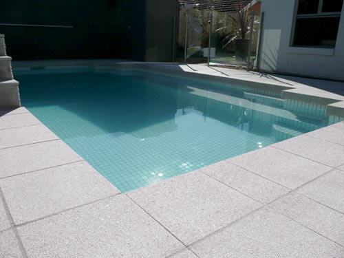 Mushroom Granite stone tile or pool paver shown in situ with matching coping