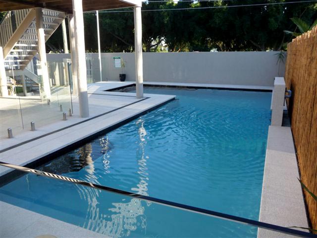 Mushroom Granite stone tile or pool paver shown in situ with matching coping