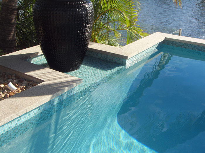 Mushroom Granite Pool stone tile or pool paver shown in situ with matching coping