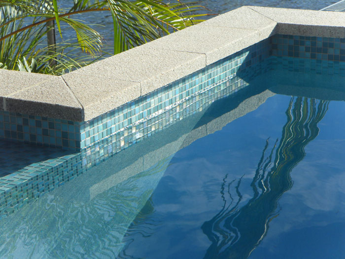 Mushroom Granite Pool stone tile or pool paver shown in situ with matching coping