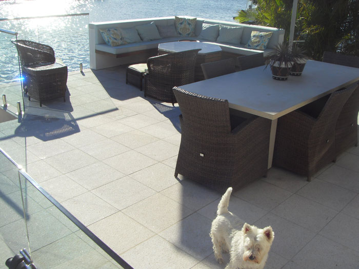 Mushroom Granite Pool stone tile or pool paver shown in situ with matching coping