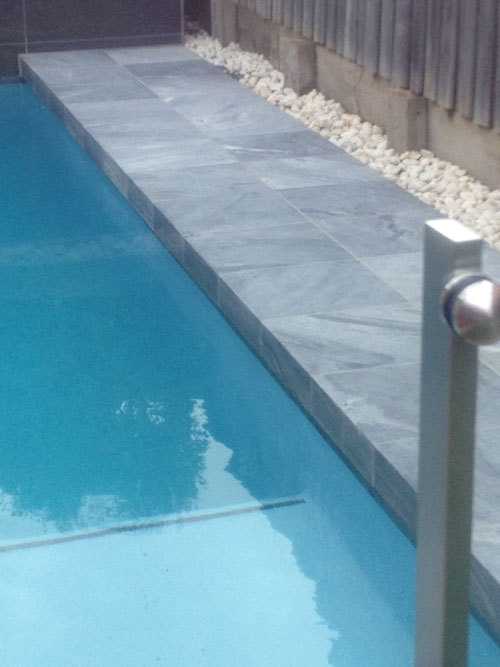 Parisian Blue stone tile or pool paver shown in situ with matching coping