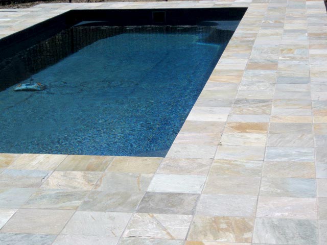 Quartzite  stone tile or pool paver shown in situ with matching coping