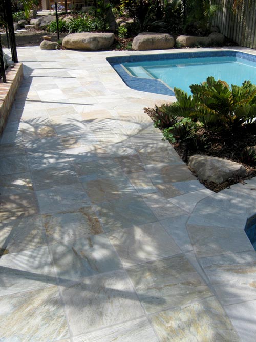 Quartzite  stone tile or pool paver shown in situ with matching coping