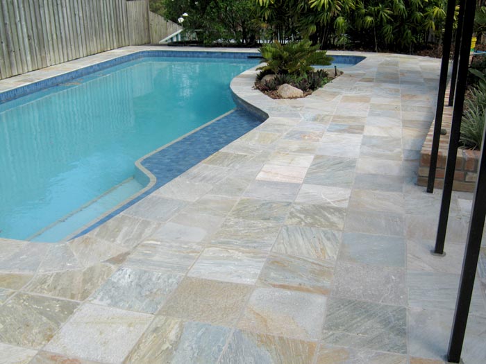 Quartzite  stone tile or pool paver shown in situ with matching coping