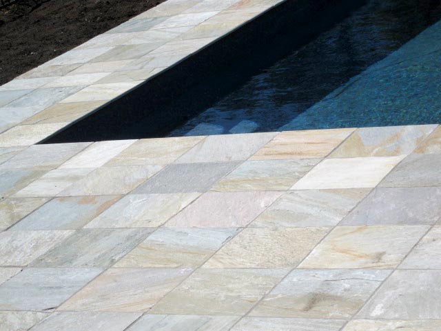 Quartzite  stone tile or pool paver shown in situ with matching coping