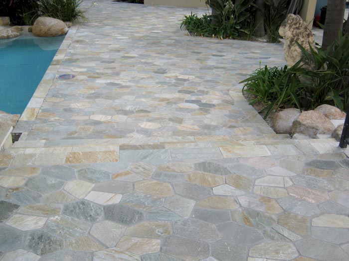 Quartzite stone tile or pool paver shown in situ with matching coping