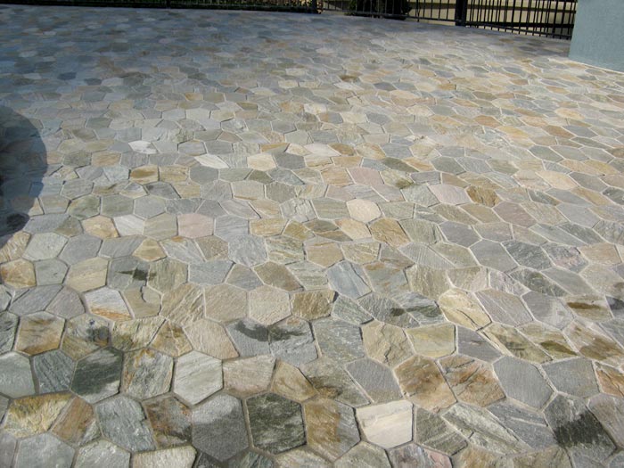 Quartzite stone tile or pool paver shown in situ with matching coping