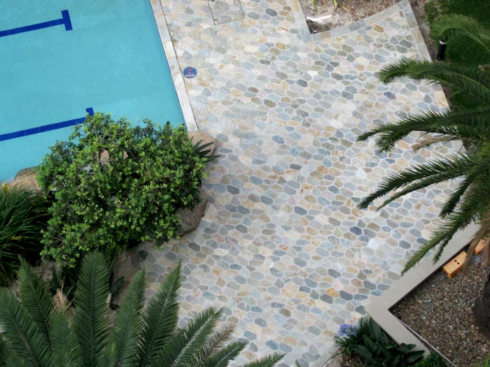 Quartzite stone tile or pool paver shown in situ with matching coping