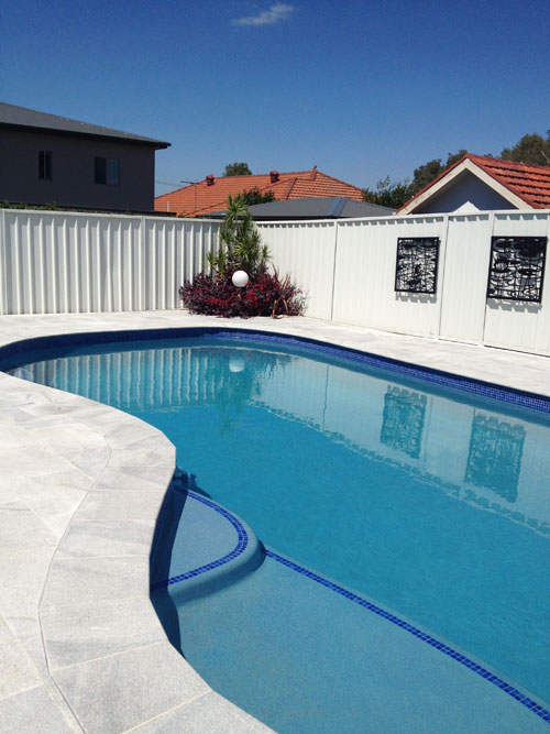 Sandwave Granite stone tile or pool paver shown in situ with matching coping