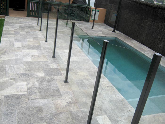 Silver Travertine Tumbled Unfilled stone tile or pool paver shown in situ with matching coping