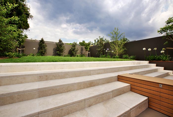 Travertine Linen natural stone being used for tiling steps and facing in a landscaped Zen garden setting