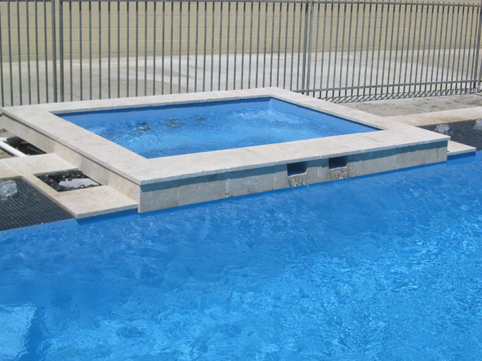 Travertine Linen stone tiles and coping around spa pool