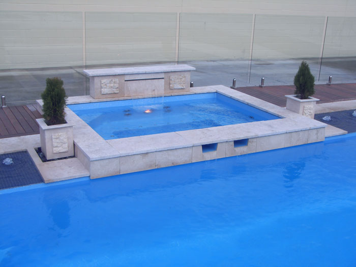 Travertine Linen stone tiles and coping around swimming pool and spa pool