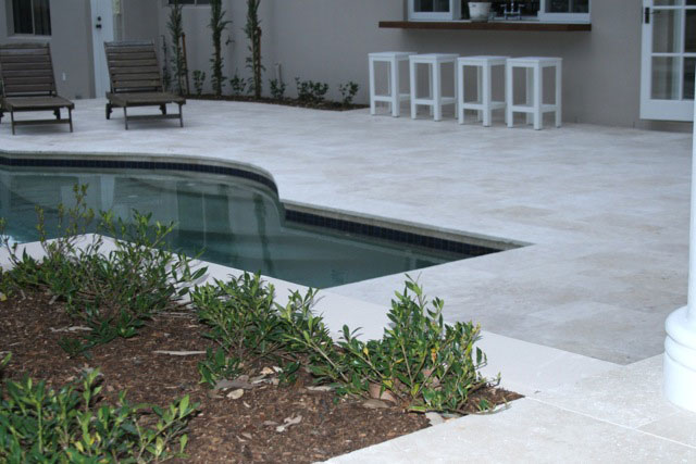 Travertine Linen stone tiles and coping around  swimming pool