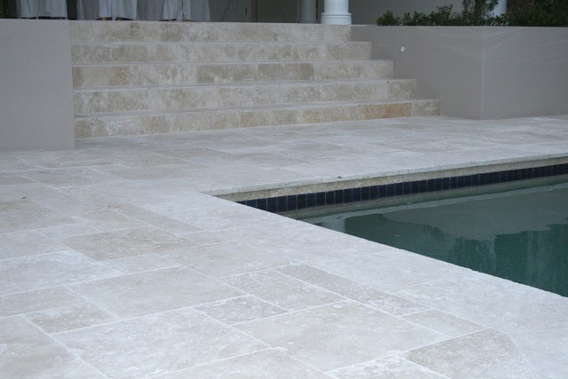 Travertine Linen stone tiles and coping around swimming pool and staircase