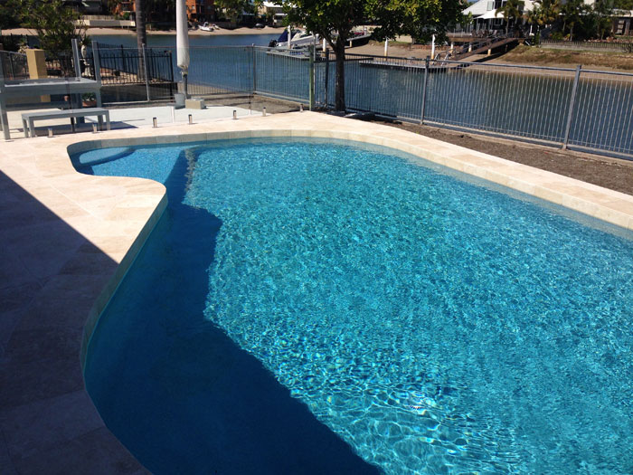 Travertine Linen stone tiles and coping around swimming pool