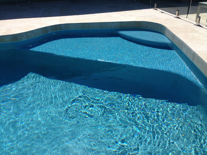 Travertine Linen stone tiles and coping around swimming pool