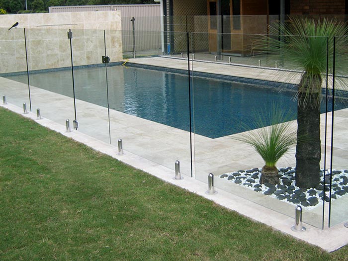 Travertine Linen stone pool feature wall and tiling and coping and glass pool fence and landscaping