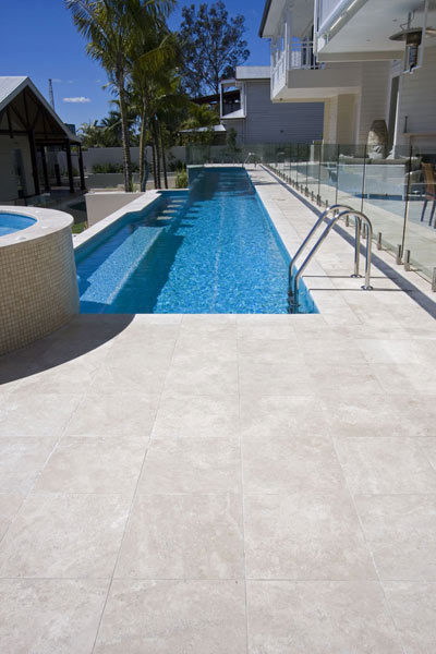 Travertine Linen stone tiles and coping around swimming pool