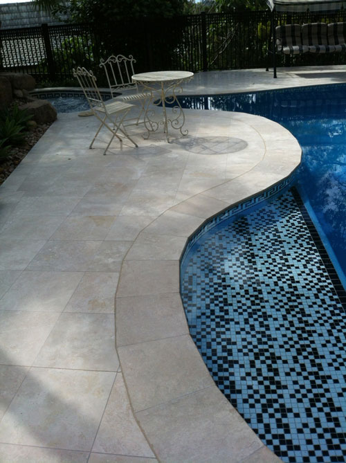 Travertine Linen stone tiles and coping around swimming pool