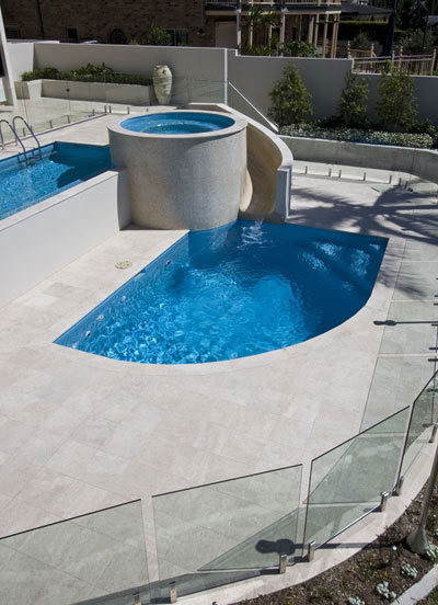 Travertine Linen stone tiles shown tiled in place around this pool, spa and wading pool also see the matching coping