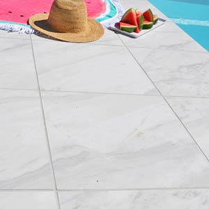 Carrara Marblano® tiles shown around a pool