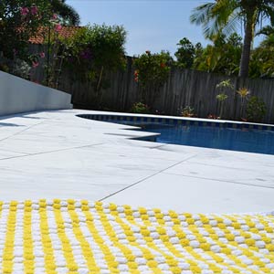 Carrara Marblano® tiles shown around a pool