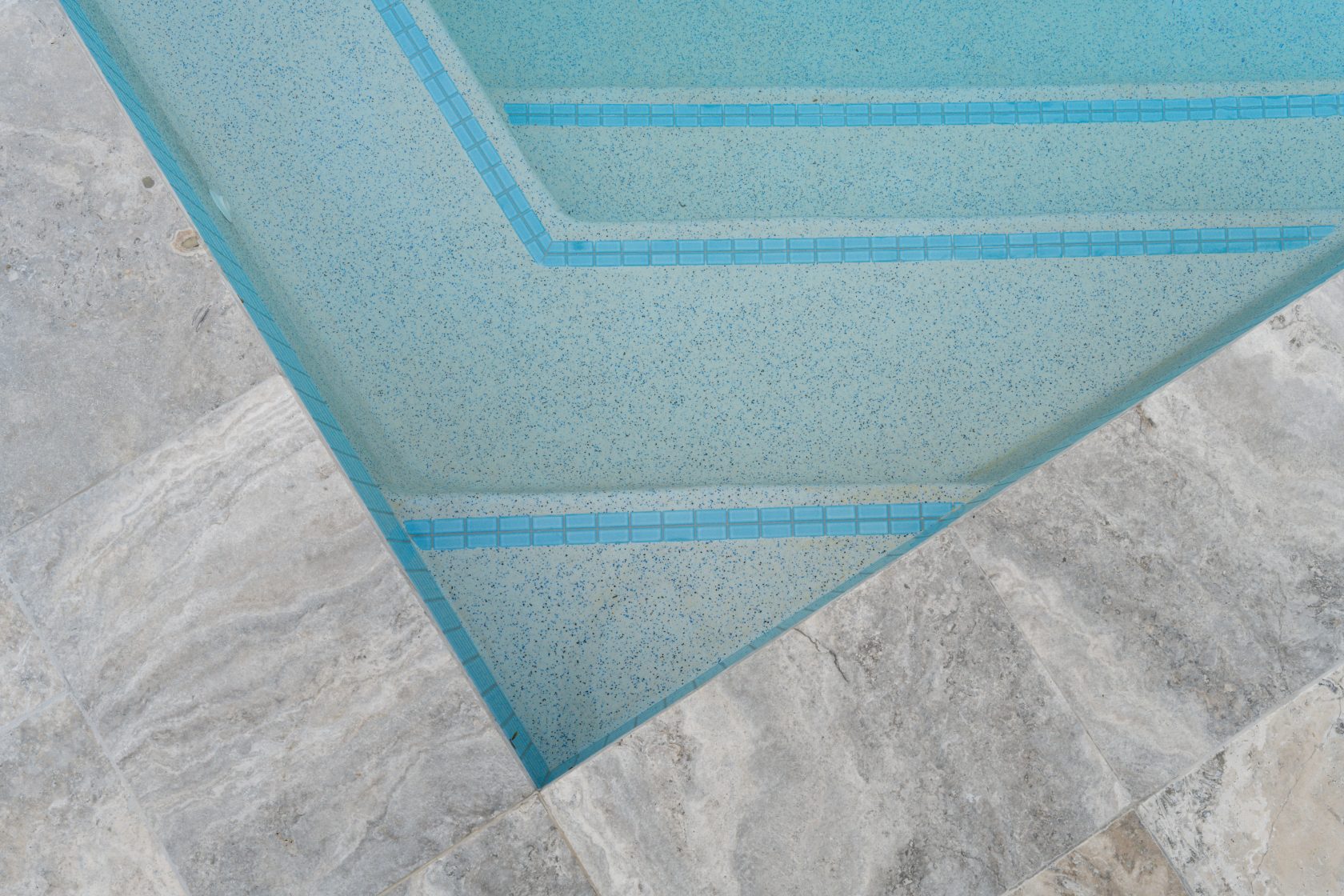 Silver Travertine walling, Silver Travertine coping and surrounds and Ice Blue waterline